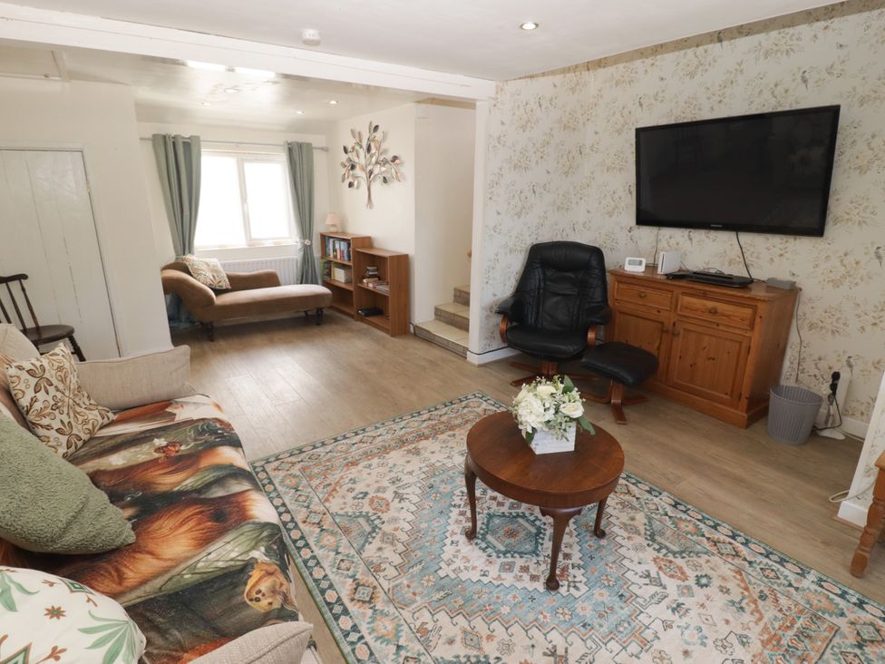 A living room with a sofa and coffee table at Farm Cottage in 