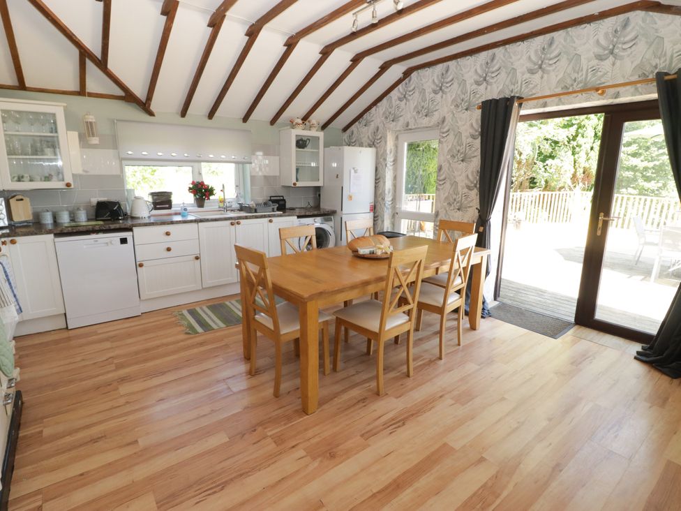 A kitchen with a dining table and chairs at Farm Cottage
