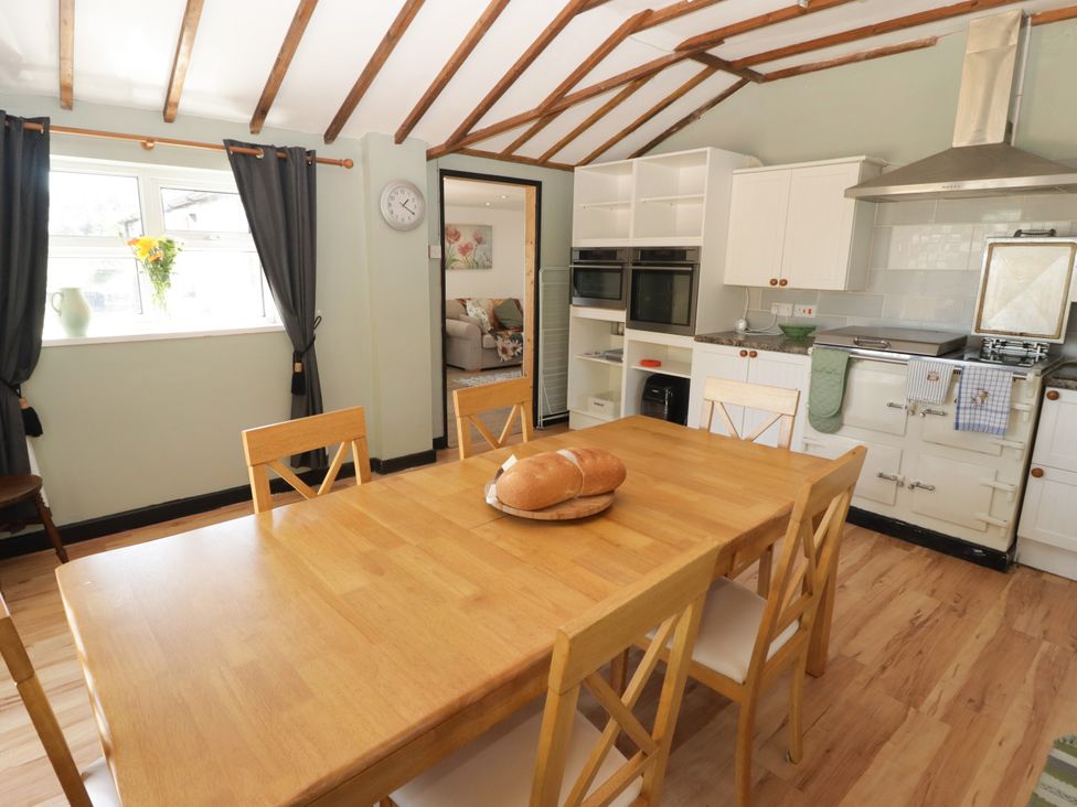 A kitchen with a dining table and bread at Farm Cottage in 