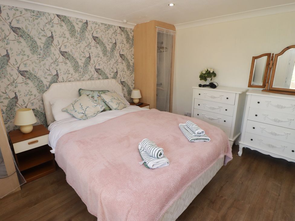 A bedroom with a bed and bedside lamp at Farm Cottage