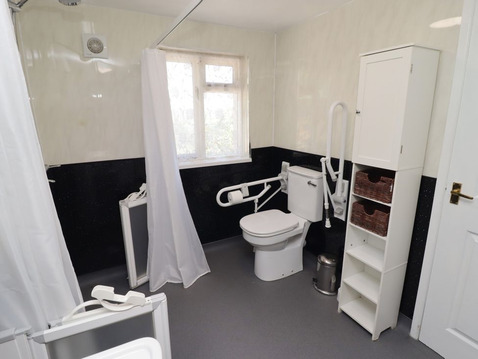 A bathroom with toilet and storage cabinet at Farm Cottage