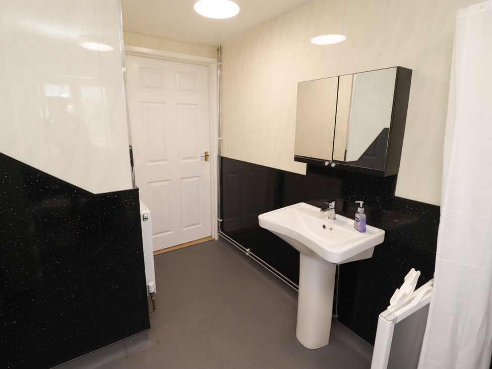 A bathroom with a sink and mirror at Farm Cottage