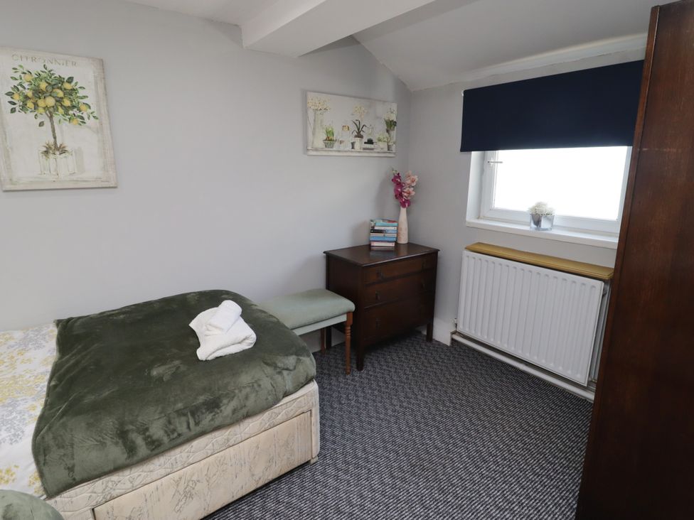 A bedroom with a bed and a chest of drawers at Farm Cottage
