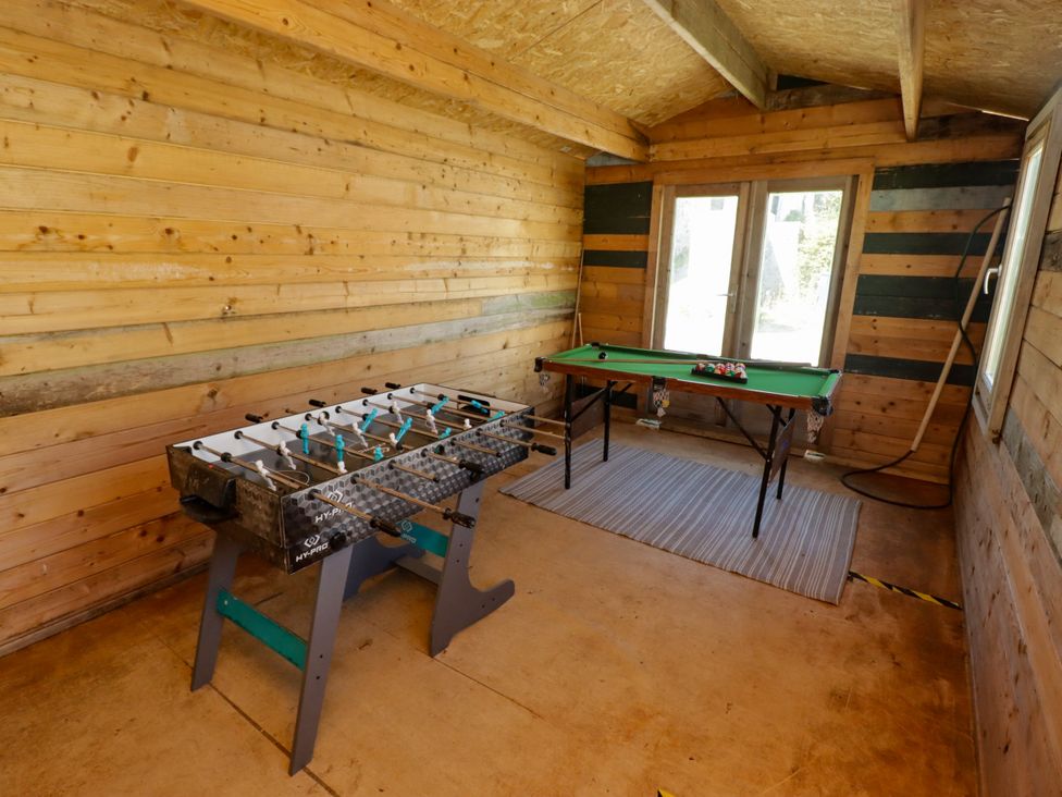 A snug with a foosball table and pool table at Farm Cottage