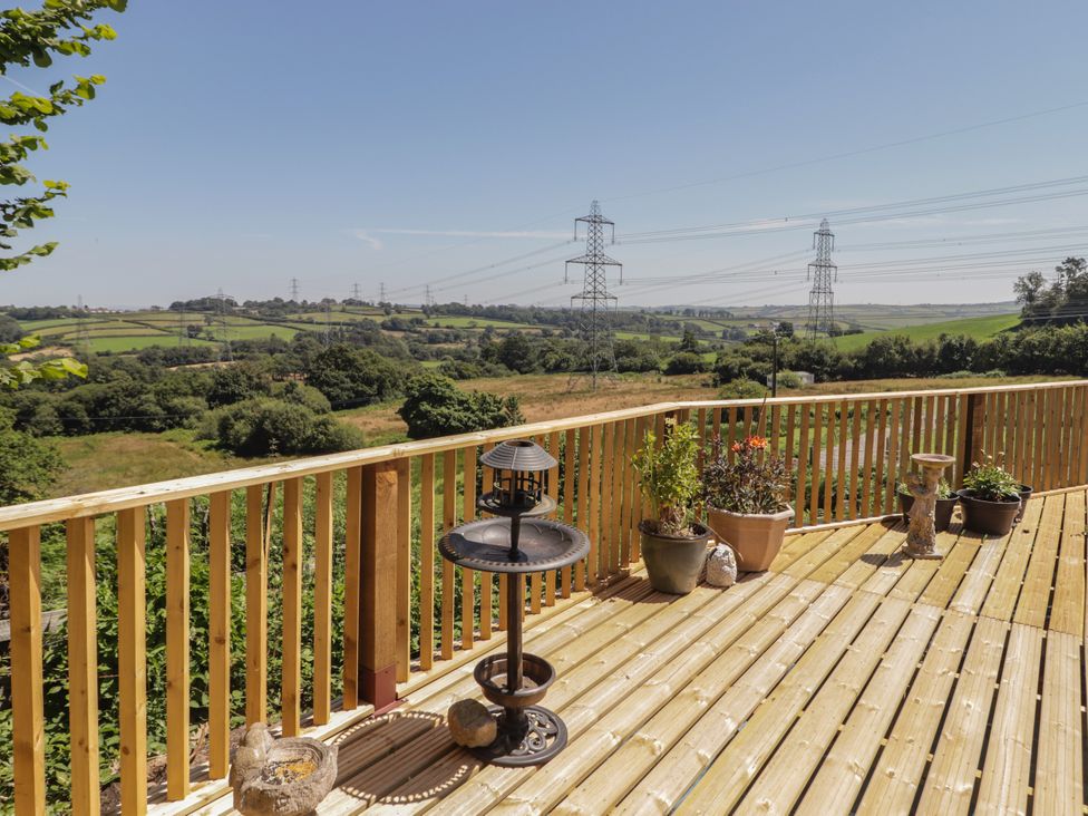 A deck with plants and views at Farm Cottage in 