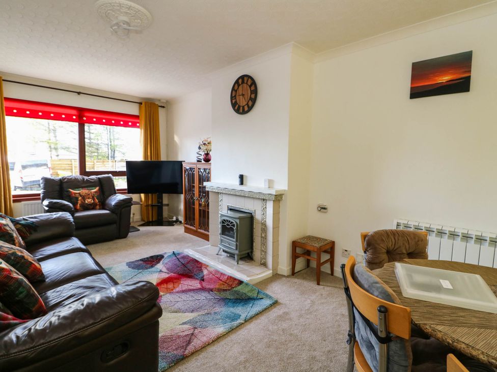 A living room with a sofa and television at 7 Creag Ruadh Laxdale near Stornoway