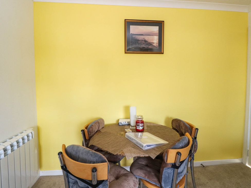 A dining room with a table and chairs at 7 Creag Ruadh near Stornoway