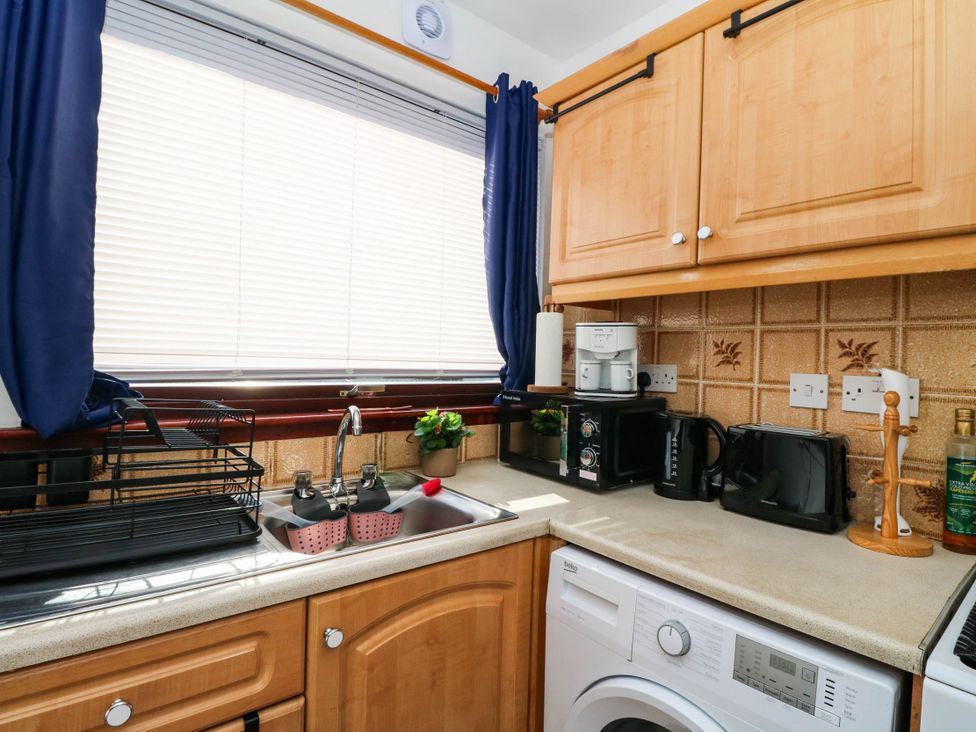 A kitchen with a sink and appliances at 7 Creag Ruadh Laxdale near Stornoway