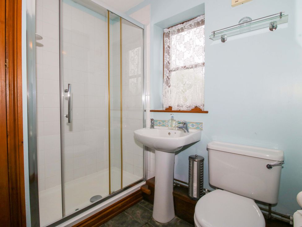 A bathroom with a shower, sink, and toilet at Apartment 2 in Lydbury North