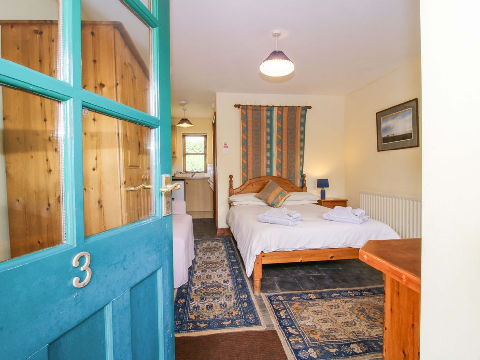 A bedroom with a bed and furniture at Apartment 3 in Lydbury North