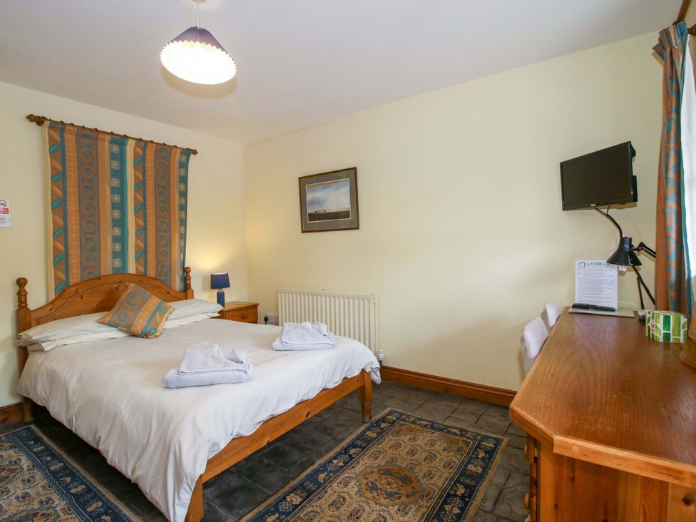 A bedroom with a bed and television at Apartment 3 in Lydbury North