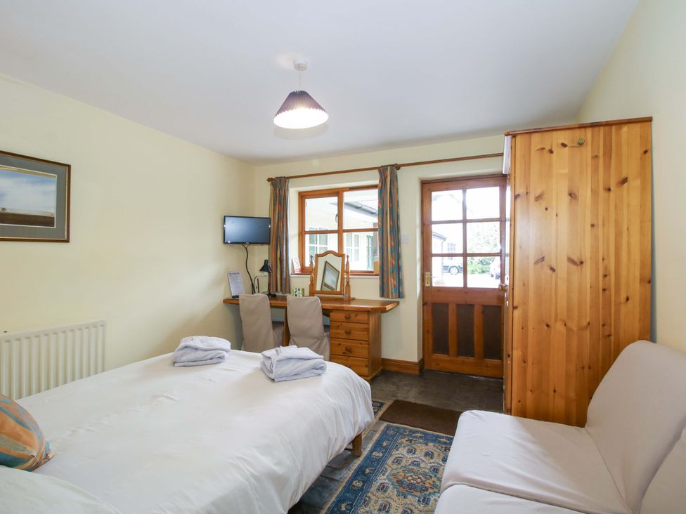 A bedroom with a bed and furniture at Apartment 3 in Lydbury North