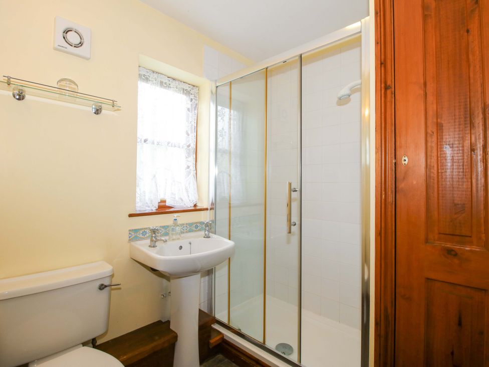 A bathroom featuring a shower, sink and toilet at Apartment 3 in Lydbury North