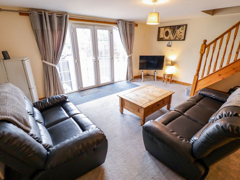 A living room with a sofa and coffee table at Holiday Cottage 1 Skegness