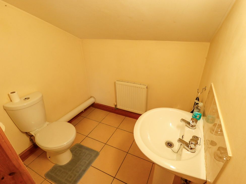A bathroom with a toilet and sink at Holiday Cottage 1 in Skegness