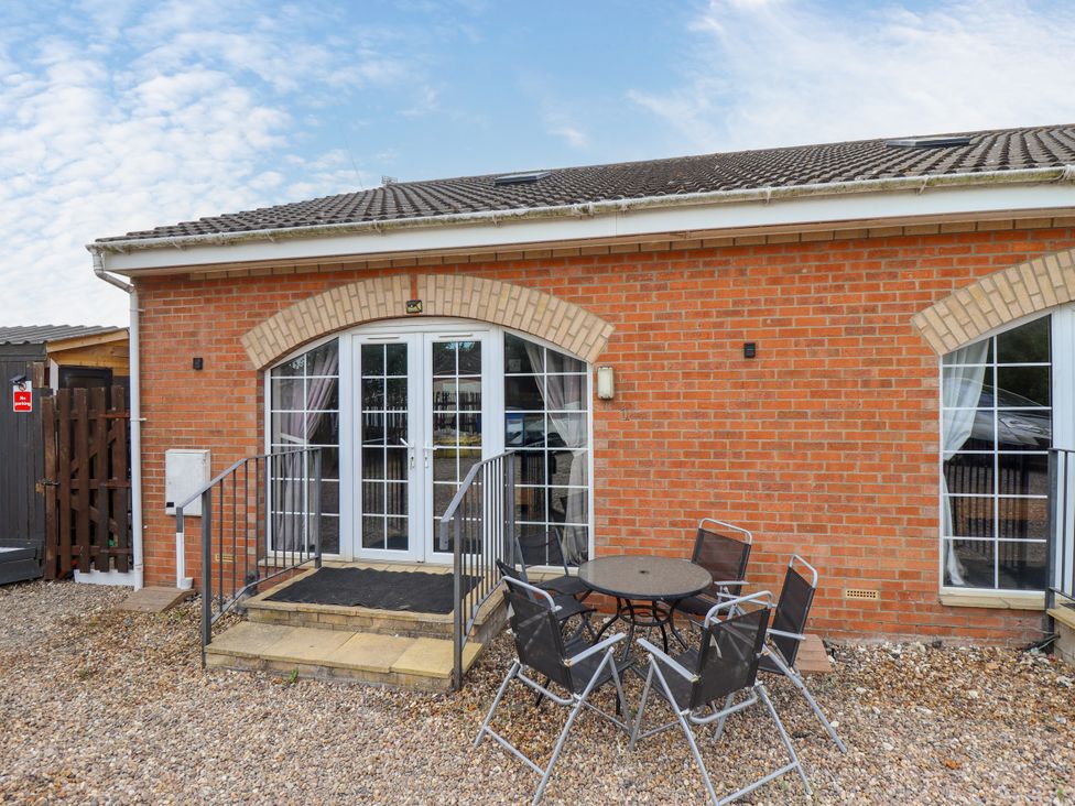 An outdoor area with a table and chairs at Holiday Cottage 1 Skegness