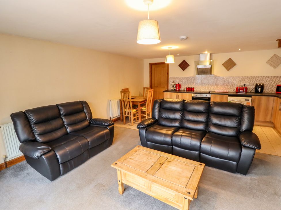 A living room with sofas and a dining area at Holiday Cottage 2 in Skegness