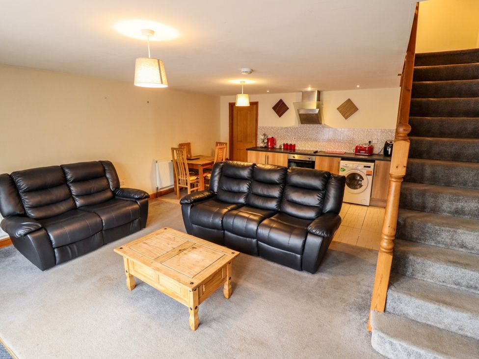 A living room with a sofa and table at Holiday Cottage 2 in Skegness