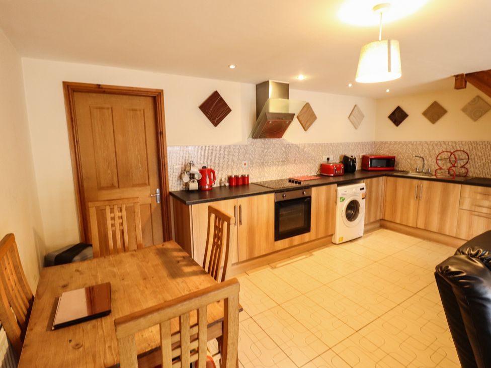 A kitchen with a table and chairs at Holiday Cottage 2 in Skegness