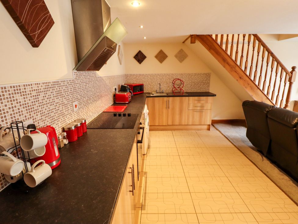 A kitchen with appliances and a sink at Holiday Cottage 2 in Skegness