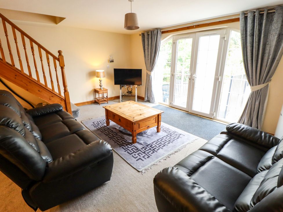 A living room with a sofa and coffee table at Holiday Cottage 3 in Skegness