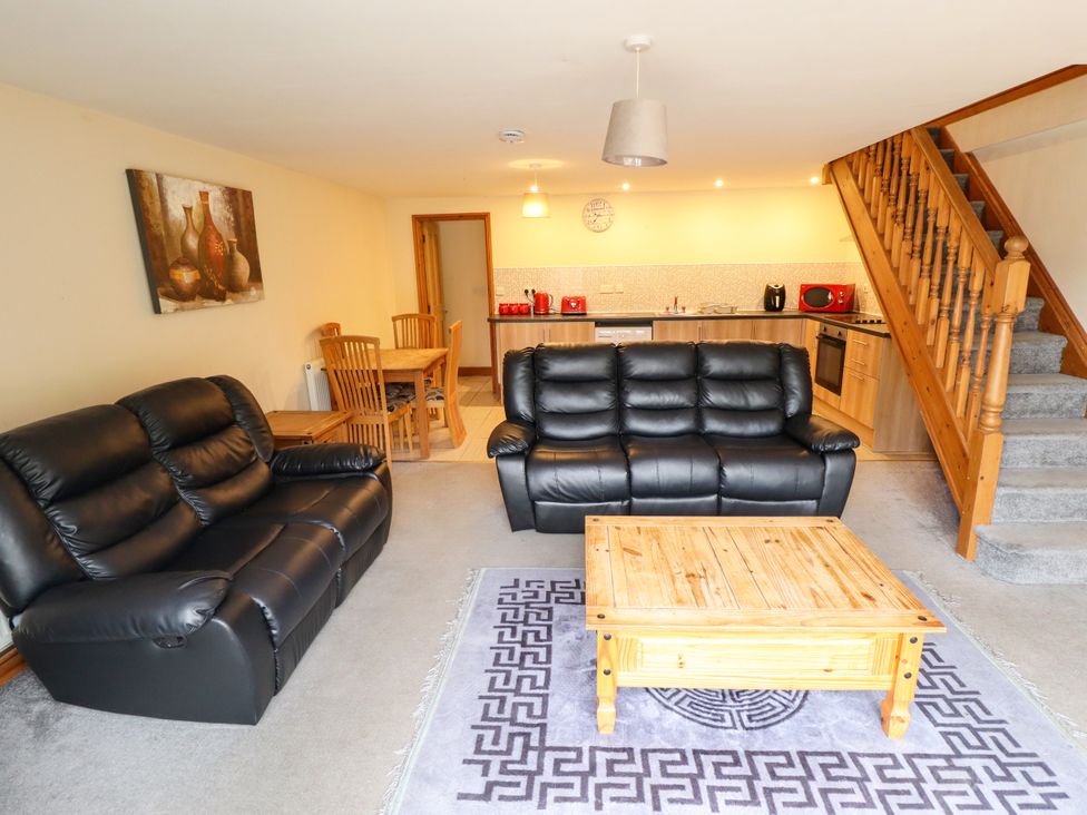 A living room with a sofa and dining area at Holiday Cottage 3 in Skegness