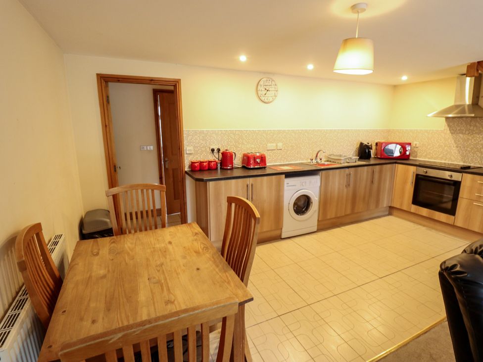 A kitchen with a table and chairs at Holiday Cottage 3 in Skegness