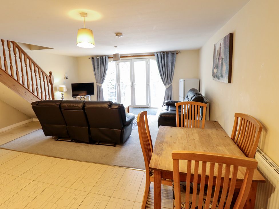 A living room with a sofa and dining area at Holiday Cottage 3 in Skegness