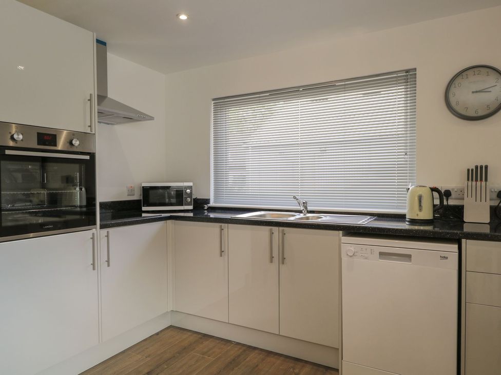 A kitchen with a sink, dishwasher, and microwave at The Cairn