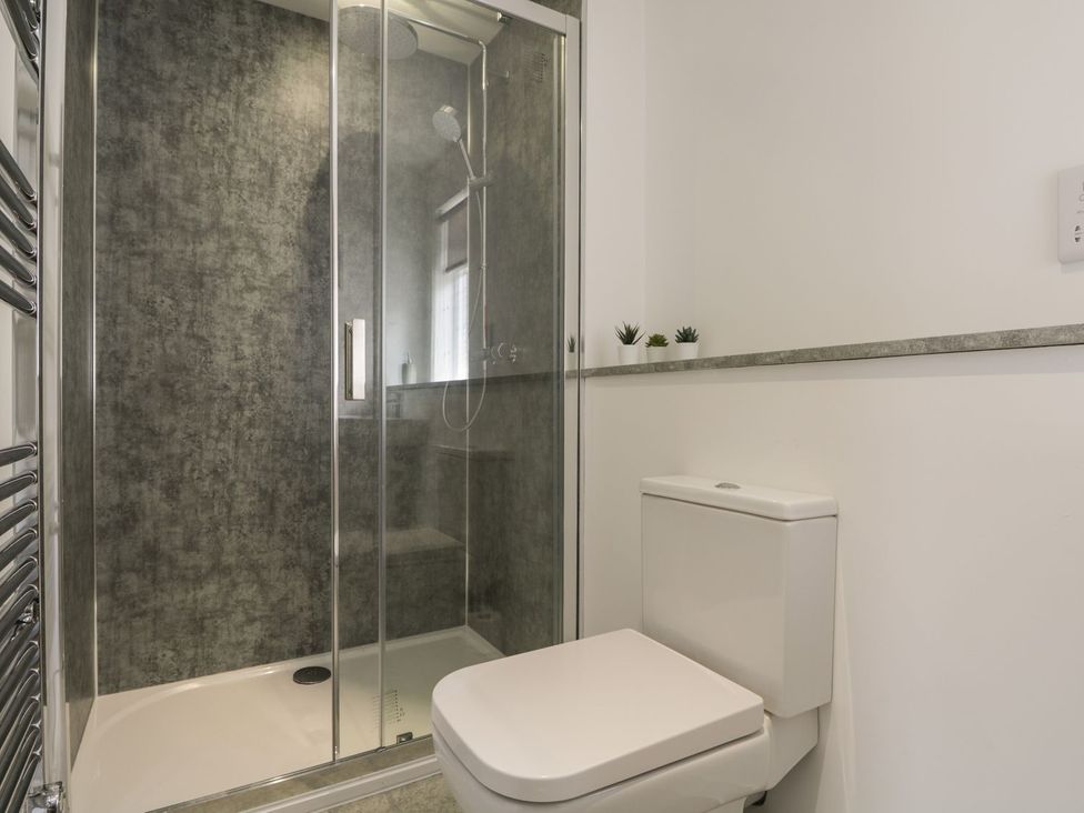 A bathroom with a shower and toilet at The Cairn 