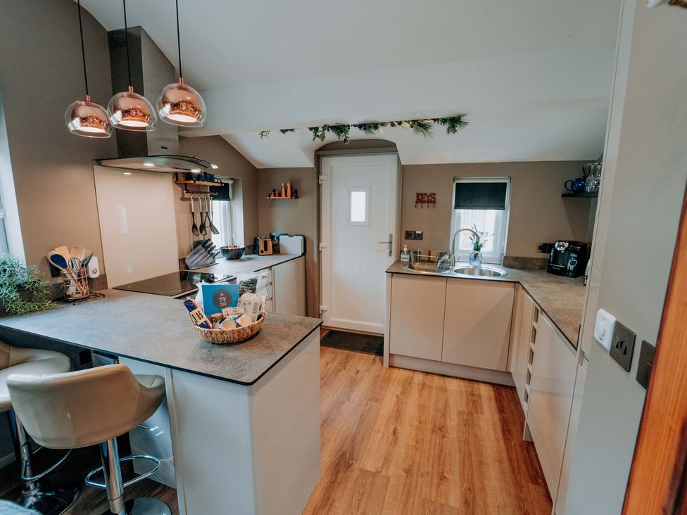 A kitchen with a countertop, sink, and cooking utensils at TyCosy in St Davids