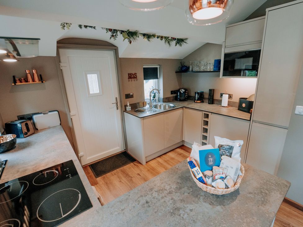 A kitchen with a sink and counters at TyCosy St Davids