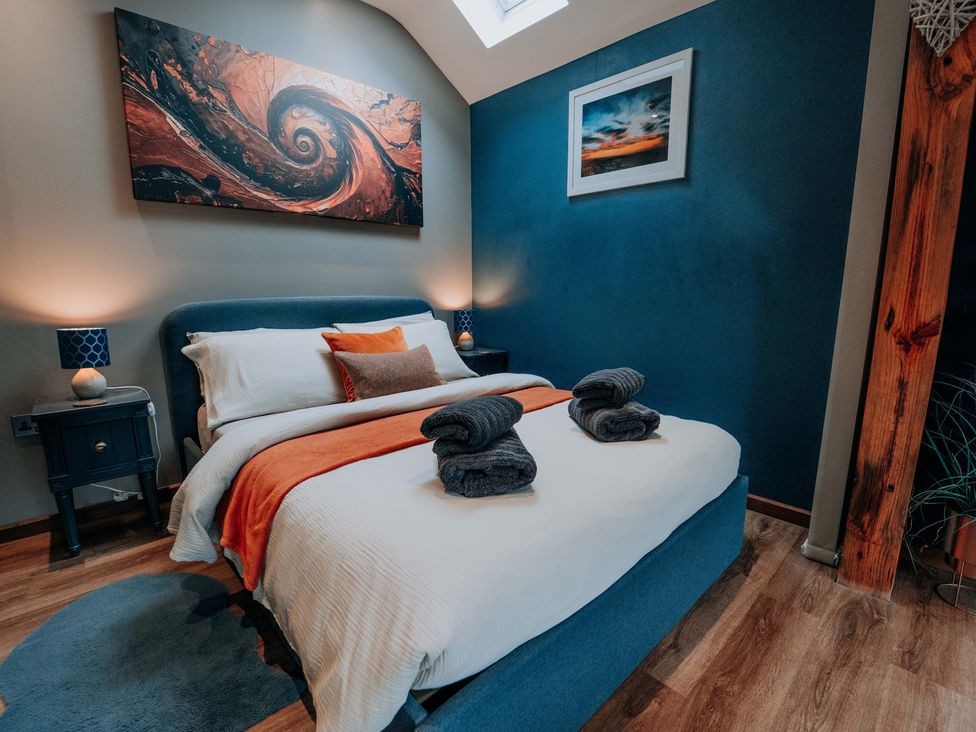 A bedroom with a bed and bedside table at TyCosy St Davids