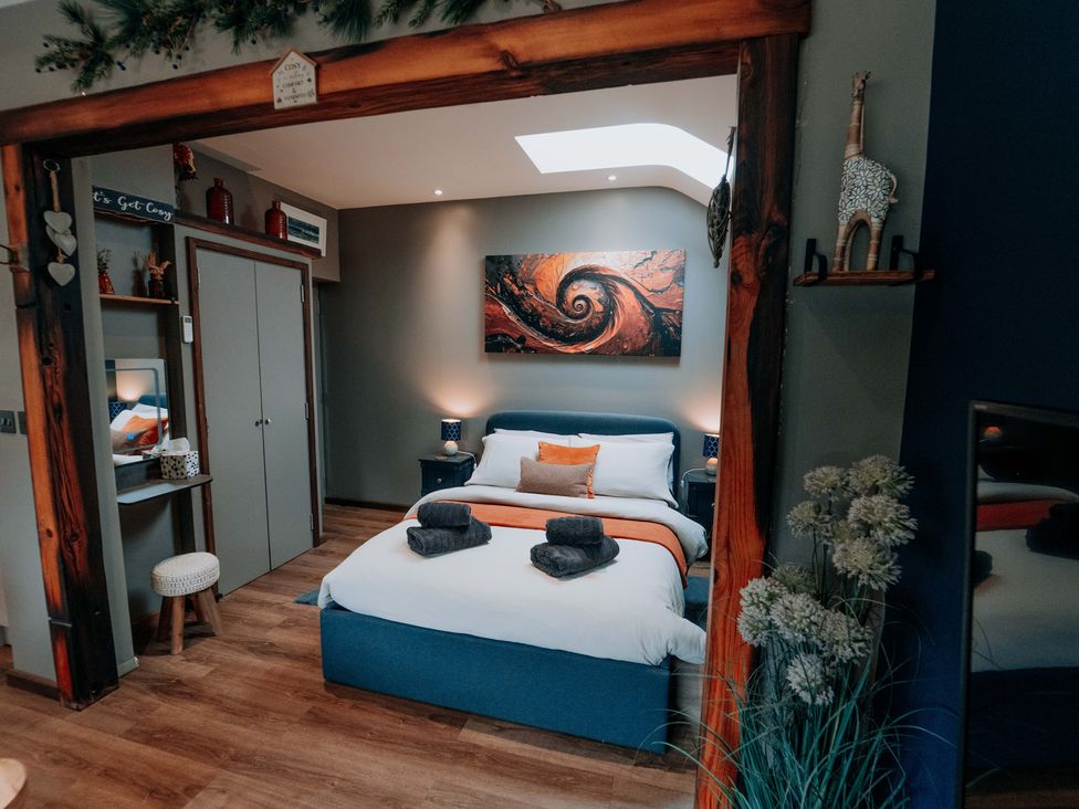 A bedroom with a bed and decorative elements at TyCosy St Davids