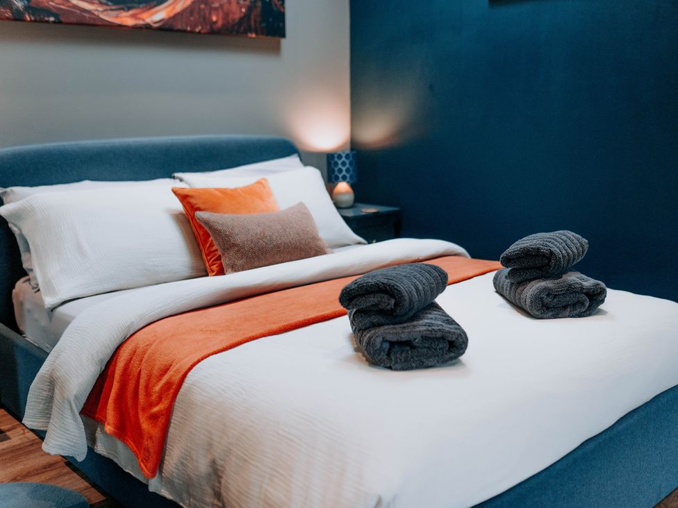 A bedroom with a bed and towels at TyCosy in St Davids
