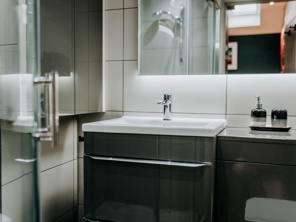 A bathroom with a sink and mirror at TyCosy in St Davids