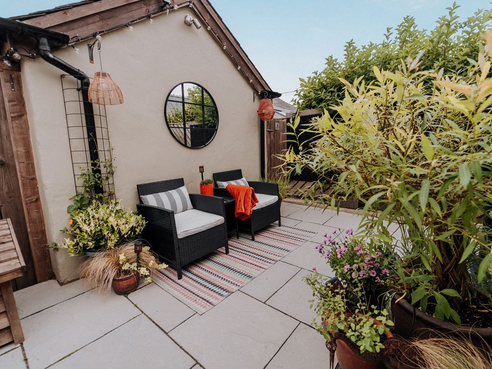 An outdoor seating area with chairs and a table at TyCosy St Davids