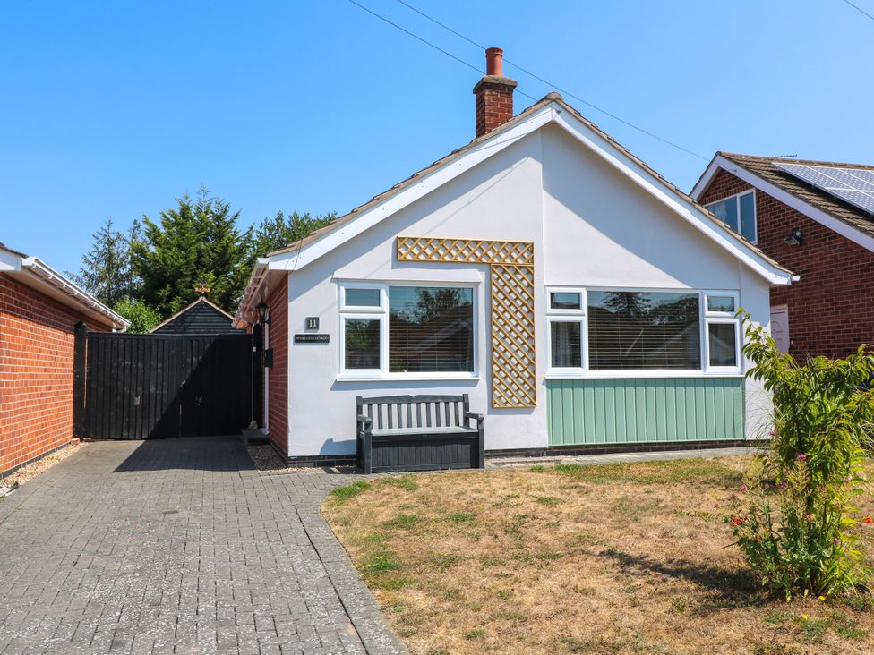 A house with a front door and garden at Pinecote Cottage Nottingham