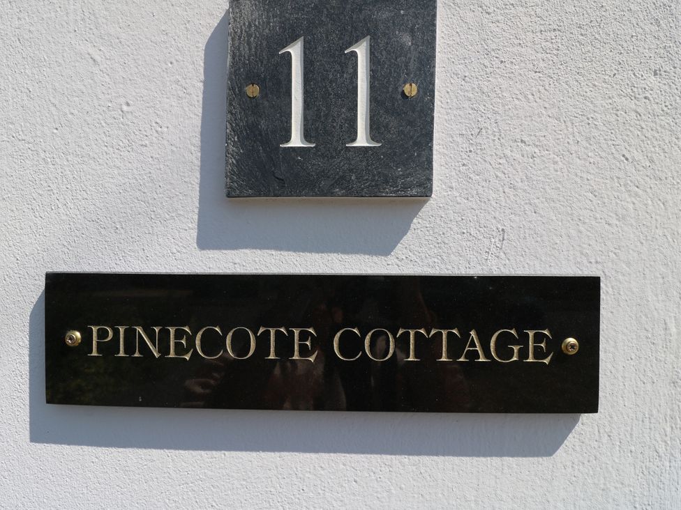 Number 11 and Pinecote Cottage name plaque on wall Nottingham