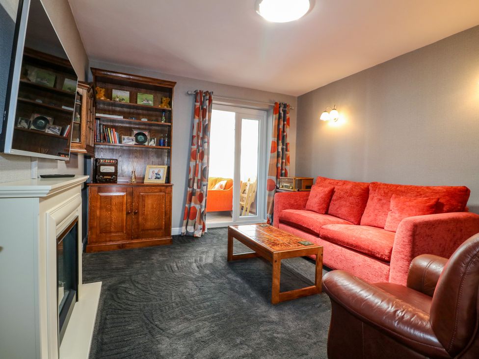 A living room with a sofa and coffee table at Pinecote Cottage Nottingham