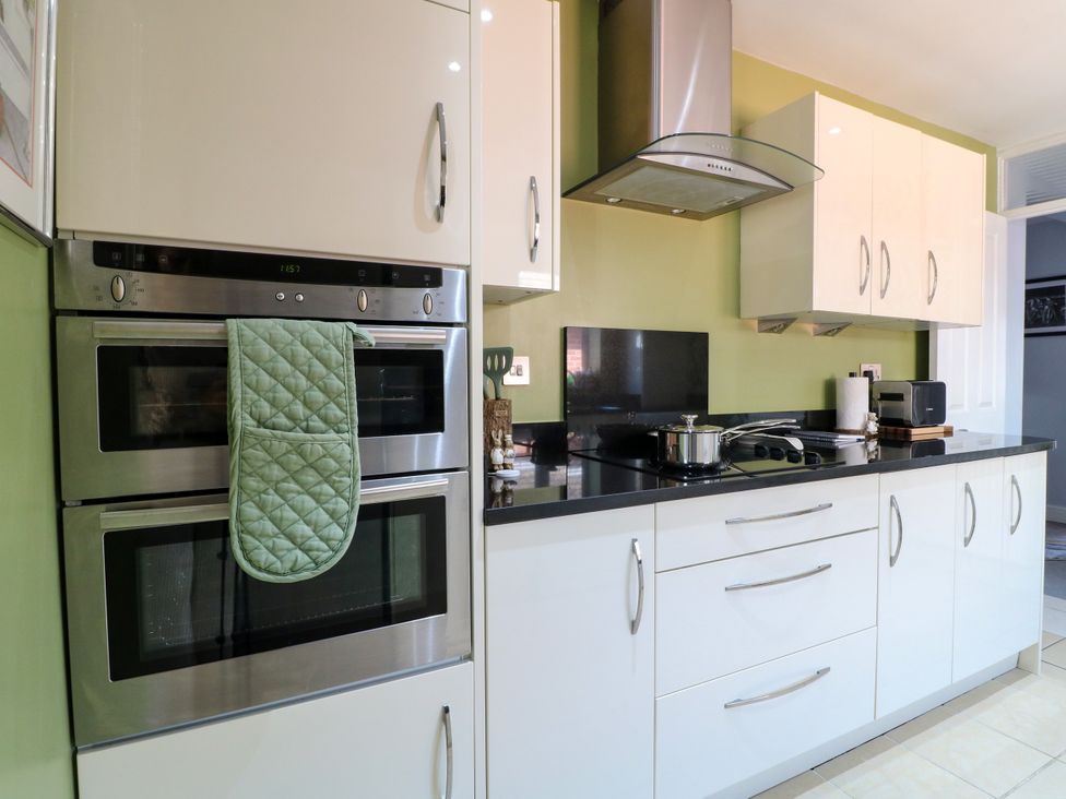 A kitchen with ovens and a cooker at Pinecote Cottage Nottingham