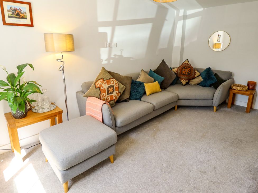 A living room with a grey sofa and cushions at Burton Fields in Brandesburton