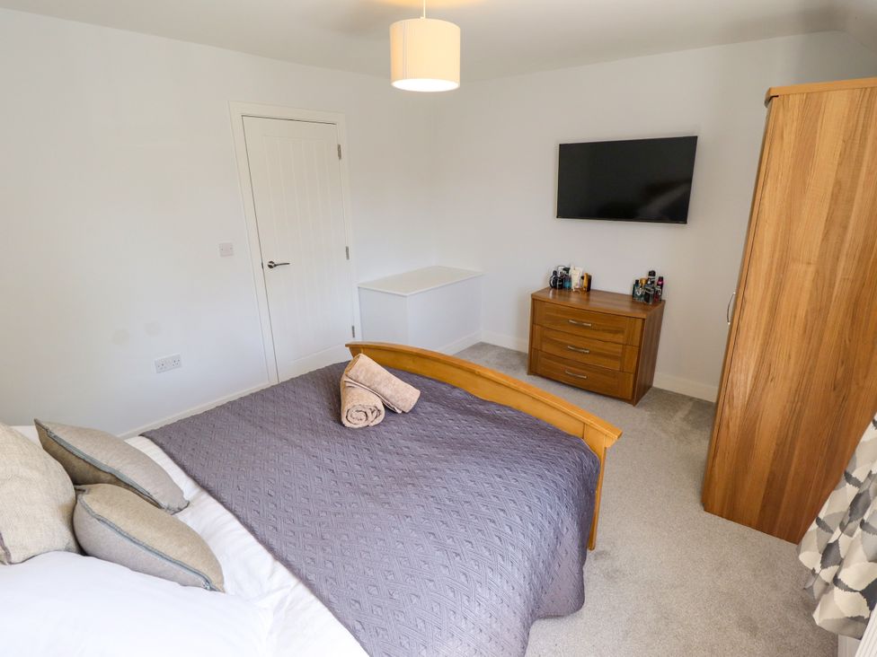 A bedroom with a bed and television at Burton Fields in Brandesburton
