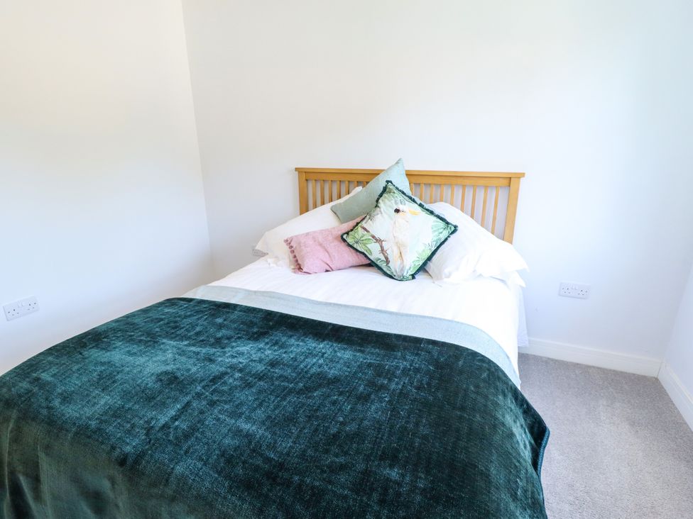 A bedroom with a bed and pillows at Burton Fields in Brandesburton