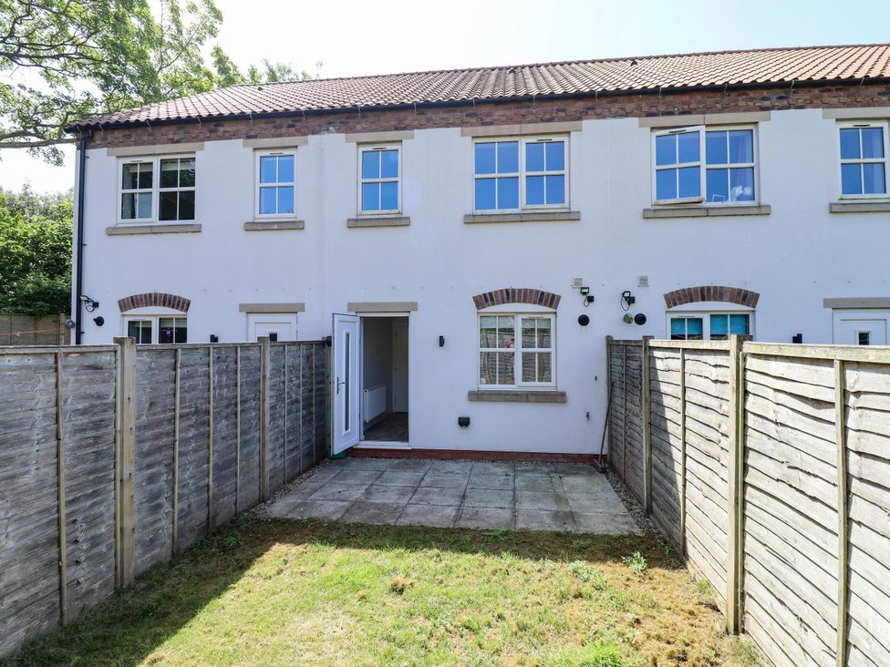 A house with windows and a patio area at Burton Fields in Brandesburton