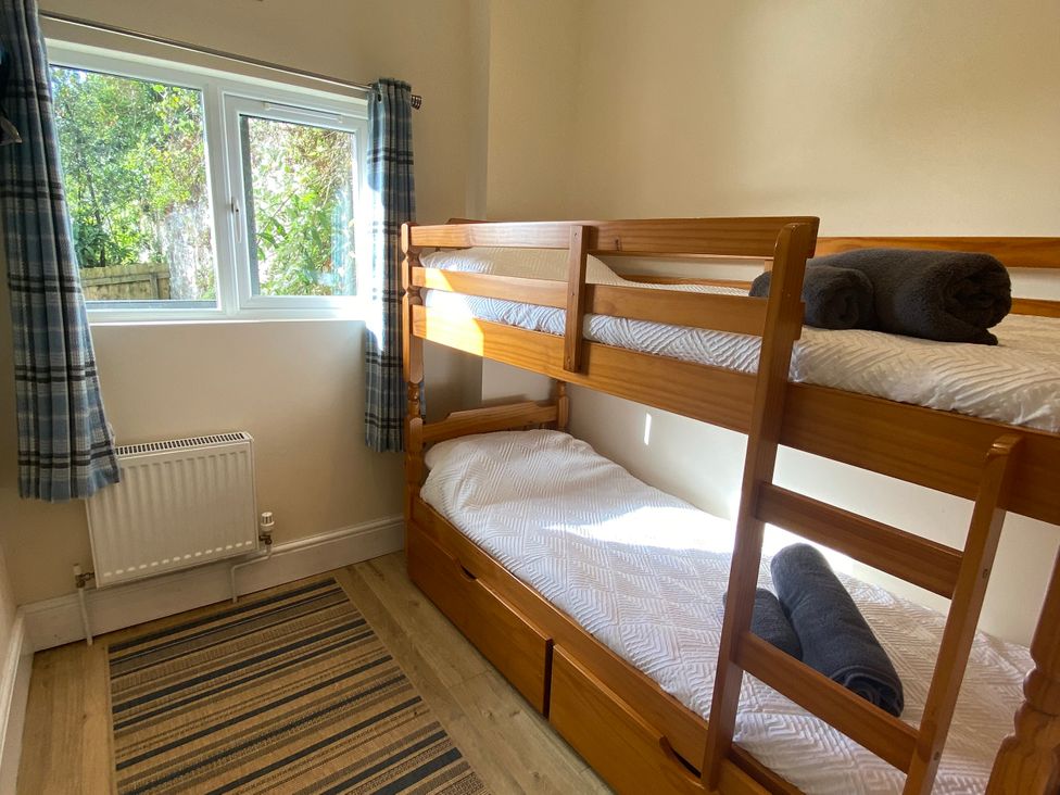 A bedroom with bunk beds and towels on Rivercrest in Looe