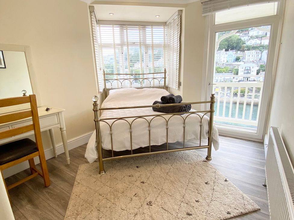 A bedroom with a bed and towels on top at Nesden House 