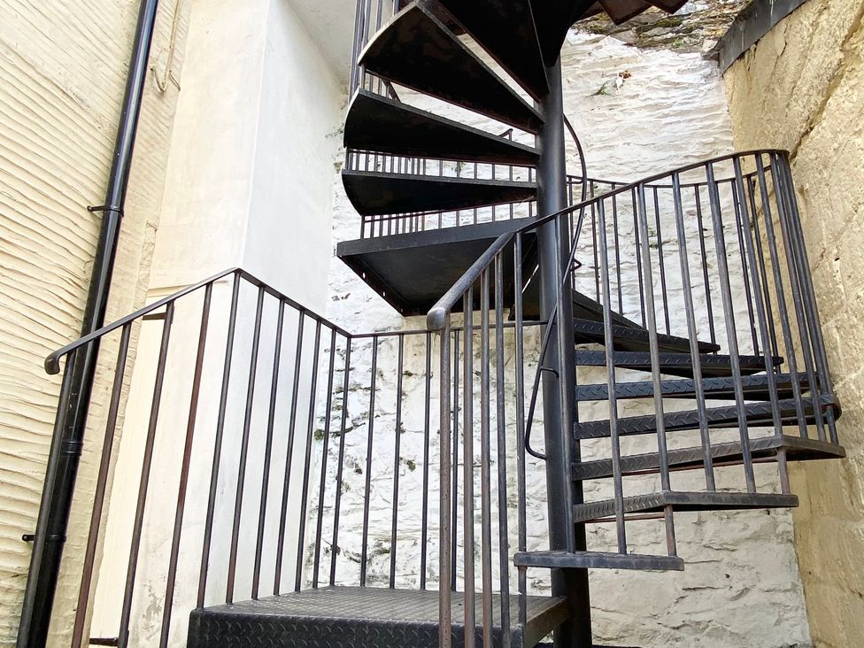 A spiral staircase in an interior space at Nesden House