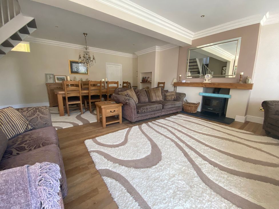 A living room with a dining area and furniture at Harbour Lodge in Looe