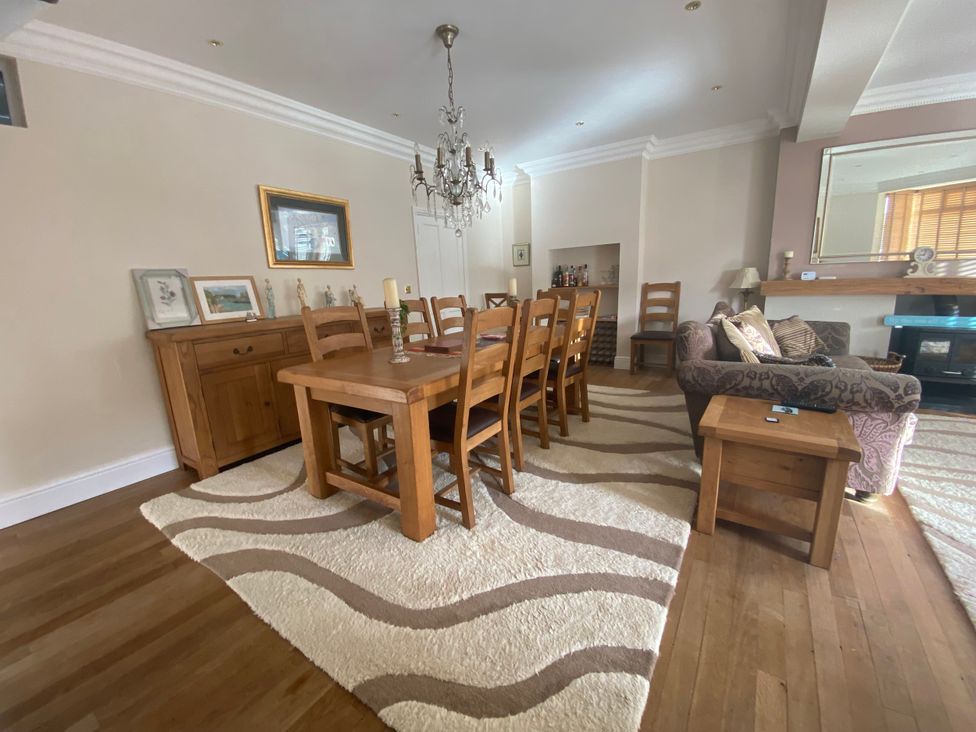 A dining room with a table and chairs at Harbour Lodge in Looe